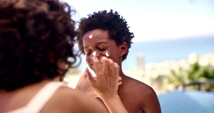 Mother, kid and sunscreen on face outdoor for sunburn prevention, UV protection and sun damage. African family, woman or spf cream application on boy for summer holiday, skincare or vacation swimming