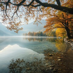 Obraz premium Autumn lake, misty mountains, golden trees, calm water, nature scene