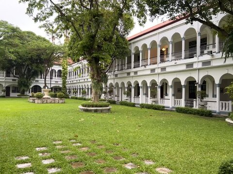 Surabaya, Indonesia - February 5 2025 : The beautiful atmosphere of the Majapahit hotel full of trees and green grass makes staying guests comfortable