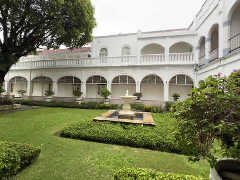 Surabaya, Indonesia - February 5 2025 : The beautiful atmosphere of the Majapahit hotel full of trees and green grass makes staying guests comfortable