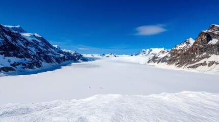 Stunning View of Glacier and Snow-Capped Mountains Under Clear Blue Sky