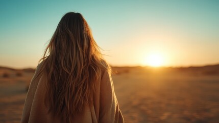 A tranquil silhouette of a woman looking at the sunset in a serene desert landscape, capturing the essence of solitude and reflection in nature's beautiful canvas.