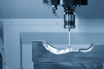The 3 axis CMM machine measuring the mold parts in the light blue scene.