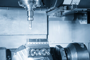 The 5-axis CNC milling machine  cutting the automotive part in the light blue scene.