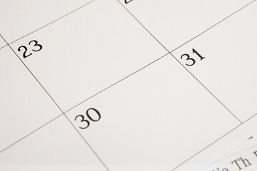 Close-up of a blank calendar page with month-end dates
