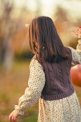 little girl playing in autumn park