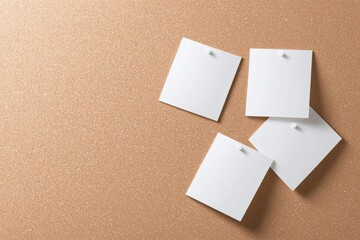 Four pristine white notes pinned to a textured corkboard, with one note playfully misaligned