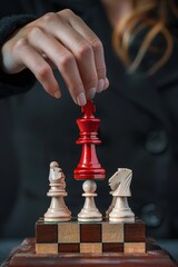 Woman puts a glossy red chess king figure on top of a pyramid, black background
