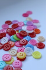 buttons on a white background, colored buttons, buttons, sewing, buttons,