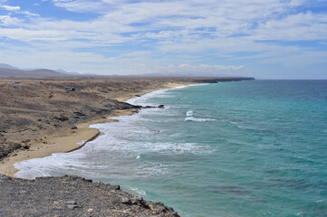 Endless lonely nature beach Playa del Castillo by the atlantic in El Cotillo, Fuerteventura, Canary...