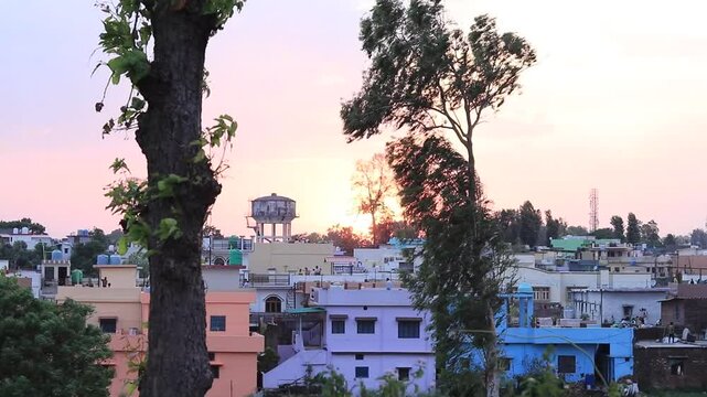 The sun is setting and the wind is blowing in the evening. sky is turnin red. A beautiful scene. A village in Dehradun. Uttarakhand. india. 05- 26-2020