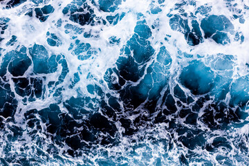 Sea water background. Top view of enchanting foamy water. Can be used in covers, packaging, posters, textures, banners, art, and design projects. Awesome nature background image.
