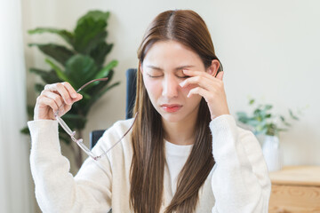 Eye care problem concept, fatigue asian young woman tired eyes irritated rubbing, massage eye dry...
