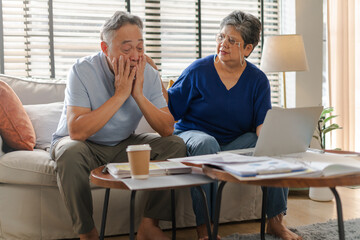 Stressed husband,asian mature retired calculate budget from...