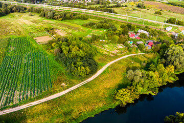 Top view of a farm on a river bank