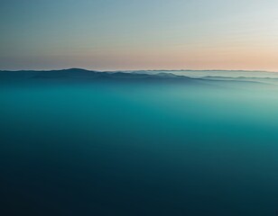 Serene twilight landscape with soft ocean hues and distant mountains fading into the horizon.