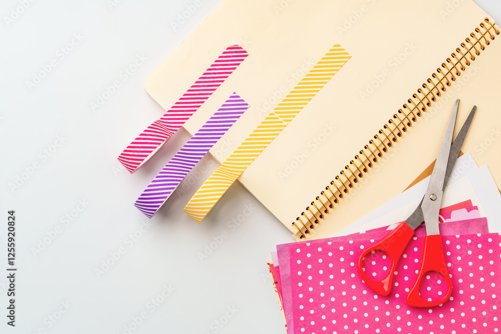 Poster crafting session with colorful paper strips and scissors on a workspace