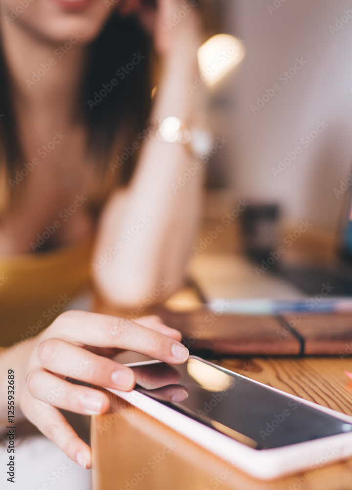 Poster selective focus on modern smartphone device used by unrecognizable female freelancer checking receiv