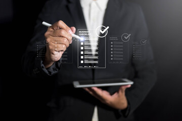 businessman using digital checklist on tablet, emphasizing productivity and organization. futuristic interface highlights efficiency in business tasks