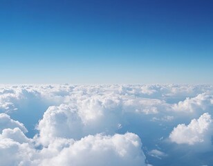 Fototapeta premium Vast blue sky above billowy white clouds, creating a serene and uplifting atmosphere.