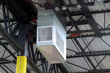 Air condition unit hanging on steel beams of warehouse ceiling 