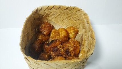 Fried gethuk isolated on white. fried gethuk in a wooden bowl. Fried gethuk is a traditional...