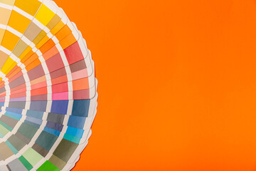 Obraz premium Color palette on a bright colored background. Color palette guide. paper catalog of rainbow color. creative.Palette, samples of trending colors. Color swatches. Decor and interior designer. Top view. 
