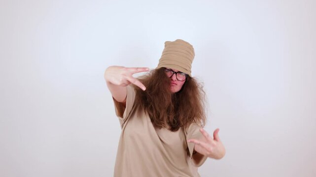 frame with hands shows V sign, victory, peace actively showing in front of face. large size, body positive, woman in beige T-shirt, hat. concept - targeting, supervision, advertising, photography, rap
