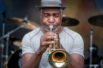 African American musician plays the trumpet.