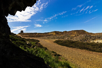 The lunar-like landscape around Parys Mountain including the Grade II Listed windmill in the distance, Amlwch, Anglesey, Gwynedd