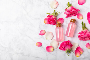 Rose essential oil on a textured background.Roses and a bottle of rose perfumed water.Aromatherapy treatment. Beauty concept. Spa procedure.Natural organic oil.Anti-stress,detox relax.Place for text