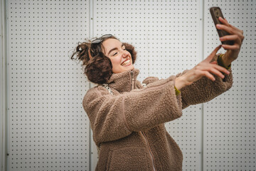 smile young woman take a self portrait or video call on mobile phone