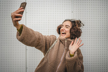 smile young woman take a self portrait or video call on mobile phone