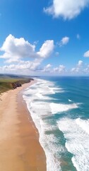 Coastal aerial view sandy beach, ocean waves, blue sky. Travel, landscape photography.