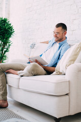 Obraz premium Content man reading book and resting