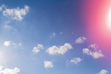 Fototapeta premium White airy beautiful clouds in a bright blue sky. Clear sunny weather. The concept of environmental safety and cleanliness..