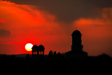Scenery sunset in the city, silhouettes of church bell towers, Sibiu, Romania, Europe, EU. Raining in the sky, beauty in Nature