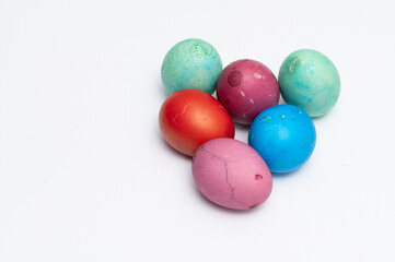 Homemade colored Easter eggs  on the white background  ready to be split to  friends and family for Easter