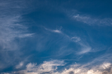 fluffy cirrus clouds in the blue sky