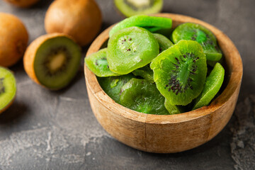 Kiwi dried fruit on wooden background. kiwi candied fruit. Healthy food. Ingredient for baking...