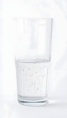 Glass of water on a white background, detailed. with white shades