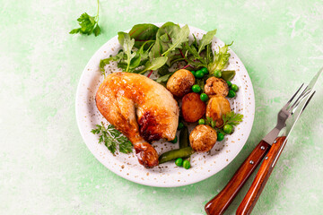 Spring lettuce leaves with new potatoes and baked chicken.