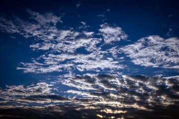 clouds at sunrise. blue sky. fluffy cirrus clouds.