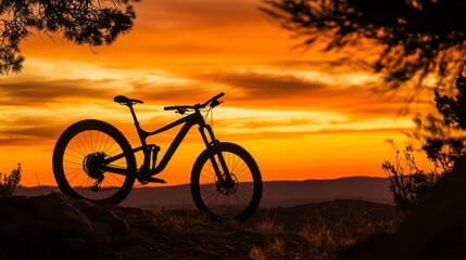 Obraz premium Majestic Sunset Silhouette of a Mountain Bike