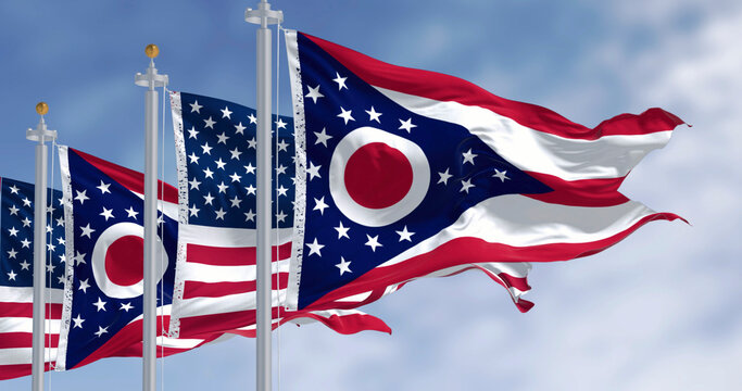 Ohio and national US flags waving in the wind on a clear day