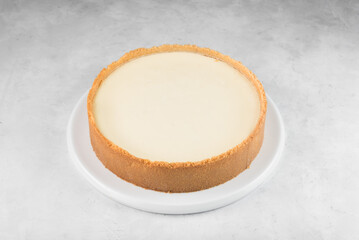 New York cheesecake on a plate on a gray background