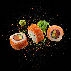 Pieces of sushi with splashes of soy sauce, isolated on black background