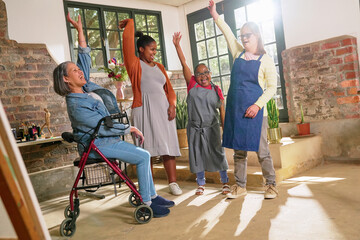 Disabled women cheering in art studio