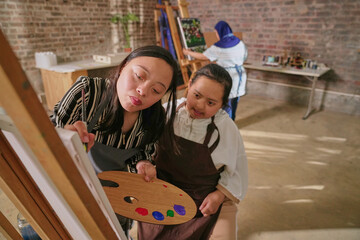 Disabled women painting during art class