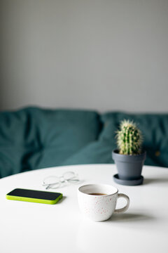 Smartphone and comfort items on a cozy home table